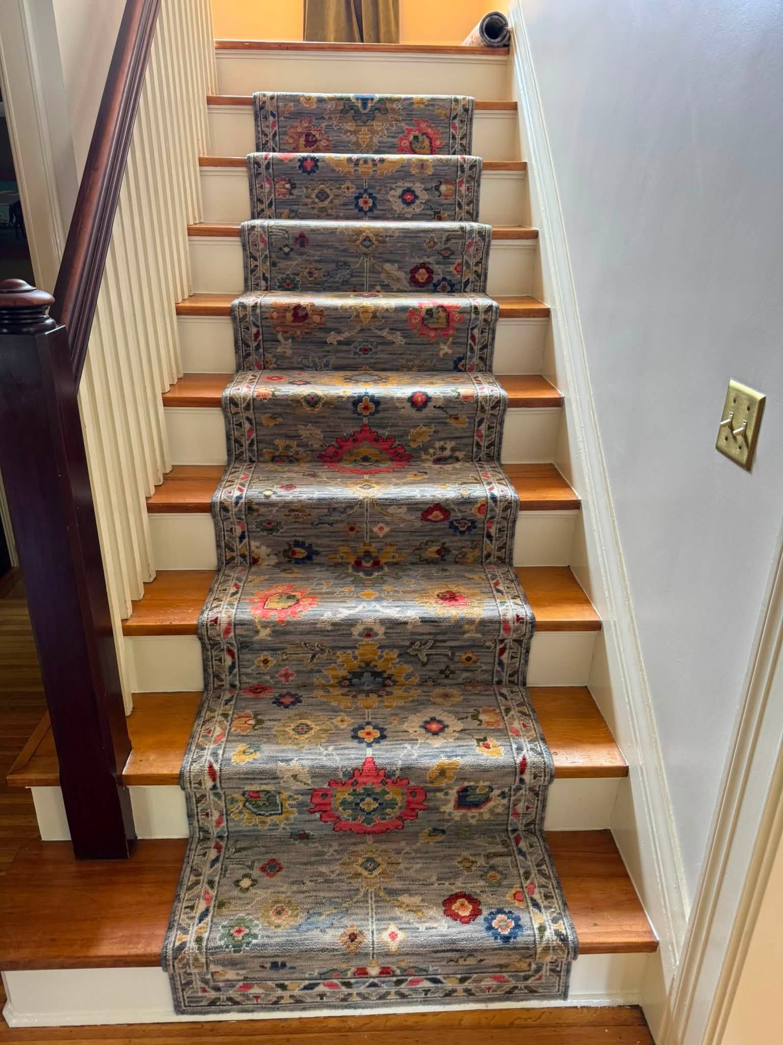A patterned carpet runner fitted to a wooden staircase by Nickels Flooring